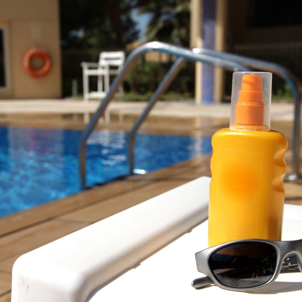 sunscreen next to a swimming pool