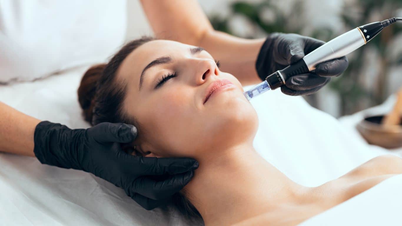 A woman is receiving microneedling treatment at Parkwood Skin Clinic.