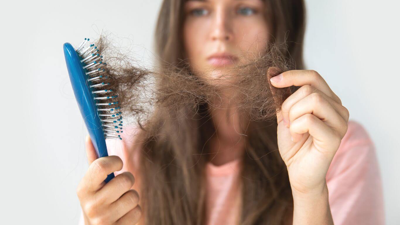 An image of a Parkwood Skin Clinic patient is frustrated with loose hair.